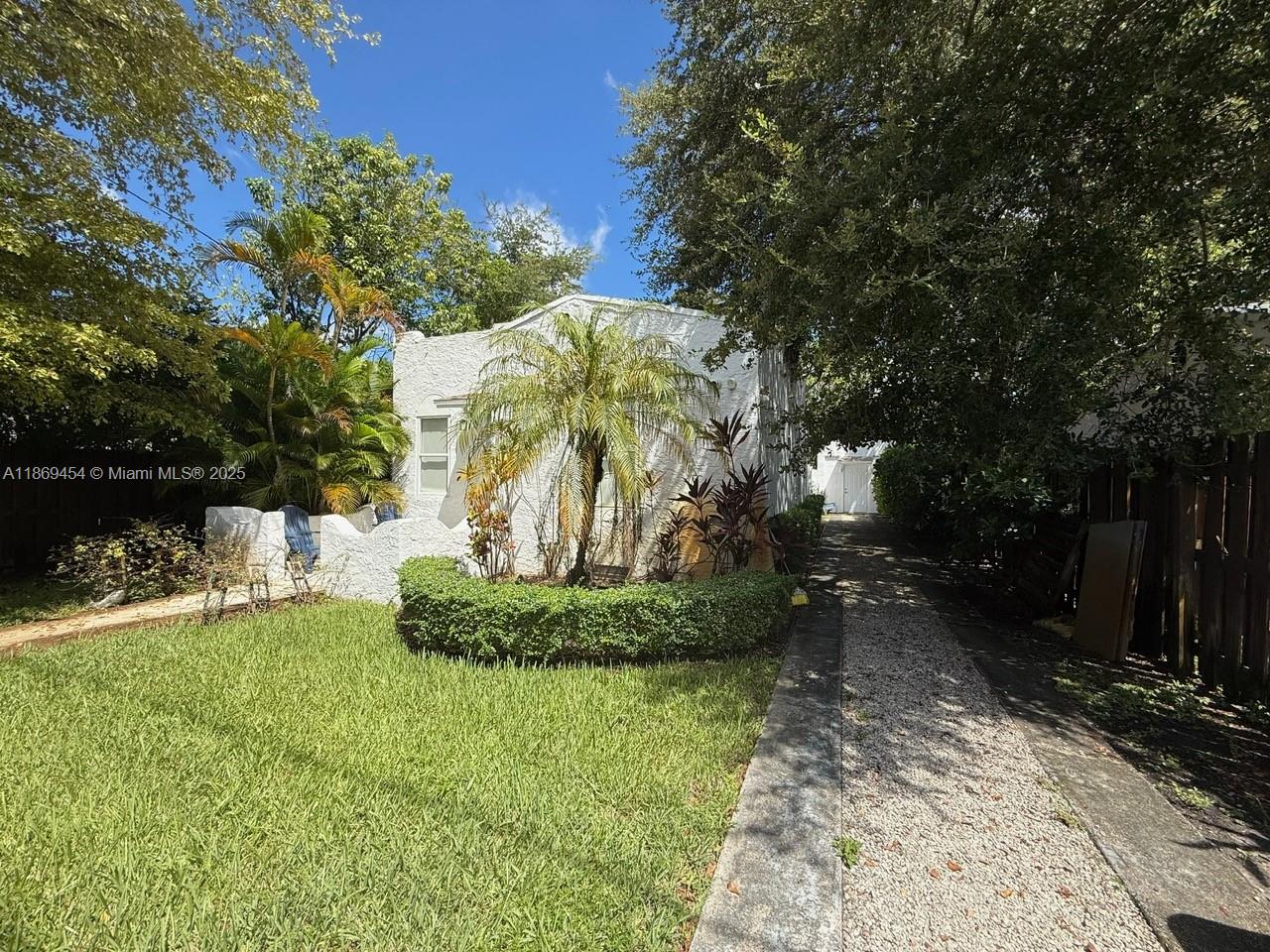 247 Northwest 58th Street Miami, FL 33127 - Photo 2 of 23 a backyard of a house with a yard and outdoor seating