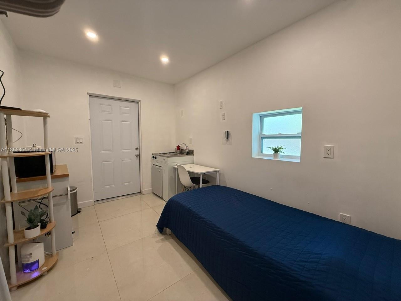 247 Northwest 58th Street Miami, FL 33127 - Photo 22 of 23 a living room with furniture and a flat screen tv