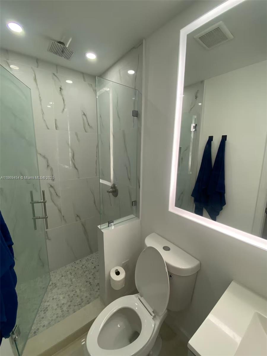 247 Northwest 58th Street Miami, FL 33127 - Photo 23 of 23 a bathroom with a granite countertop toilet sink and shower