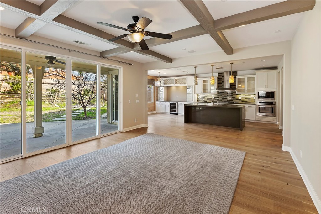 11548 Grimaldi Road Rancho Cucamonga, CA 91701 - Photo 16 of 39 a large kitchen with stainless steel appliances granite countertop a lot of counter space and wooden floors