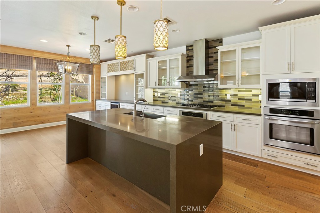 11548 Grimaldi Road Rancho Cucamonga, CA 91701 - Photo 18 of 39 a kitchen with stainless steel appliances granite countertop a sink and a stove