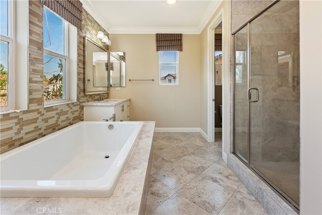 11548 Grimaldi Road Rancho Cucamonga, CA 91701 - Photo 33 of 39 a bathroom with a bathtub and shower