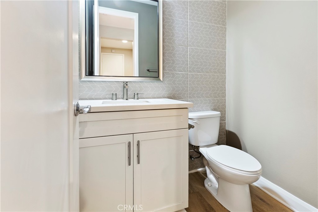 11548 Grimaldi Road Rancho Cucamonga, CA 91701 - Photo 9 of 39 a bathroom with a toilet sink vanity and mirror