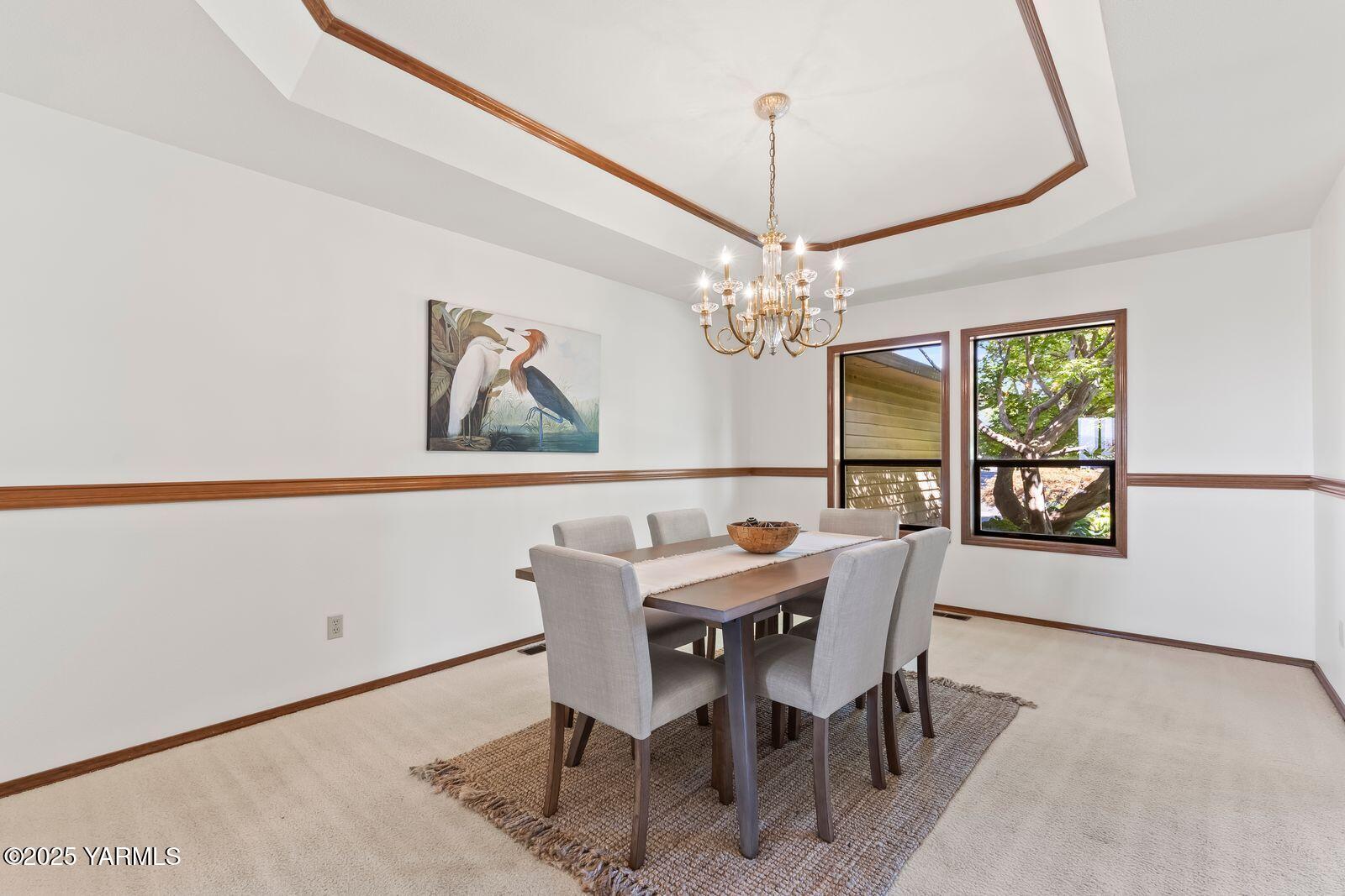 720 Country Club Drive Yakima, WA 98901 - Photo 13 of 48 a view of a dining room with furniture a chandelier and wooden floor