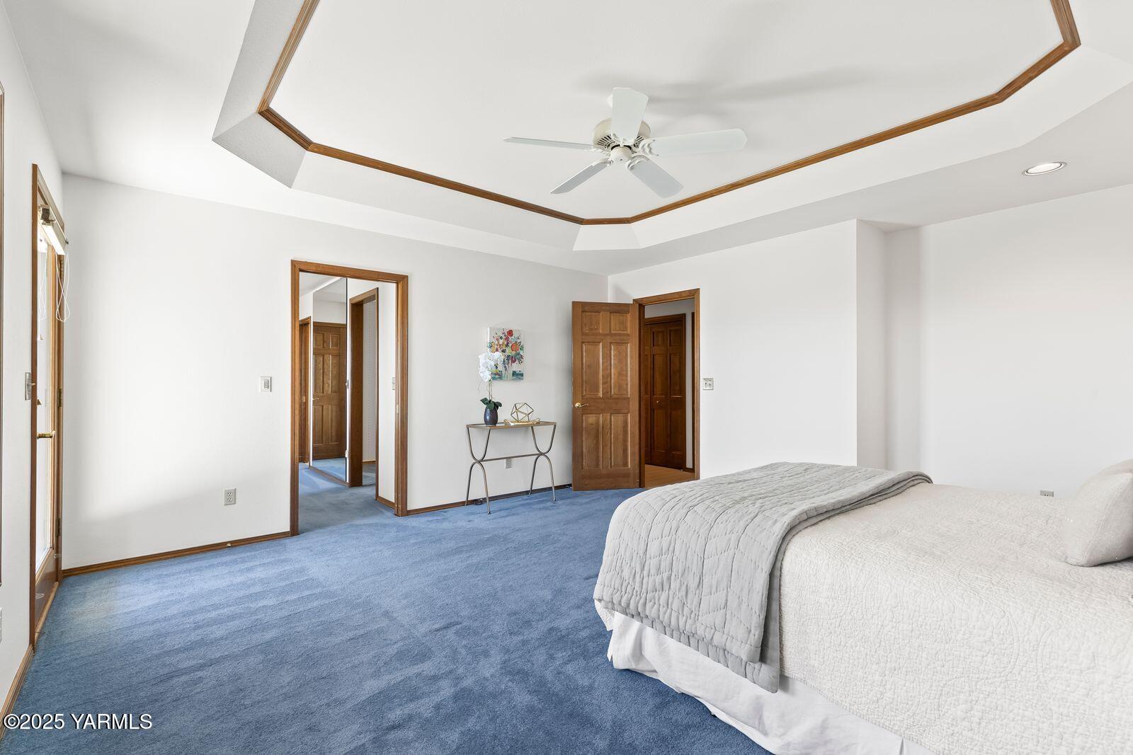 720 Country Club Drive Yakima, WA 98901 - Photo 35 of 48 a spacious bedroom with a bed and a chandelier