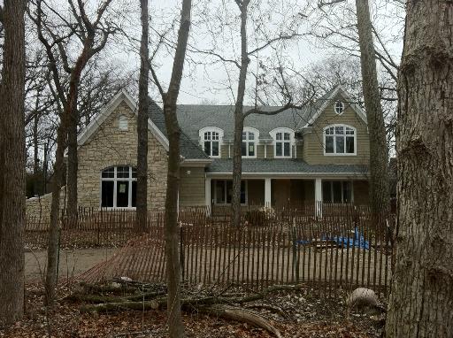 1717 Ridge Road Highland Park, IL 60035 - Photo 1 of 12 front view of a house with a bench