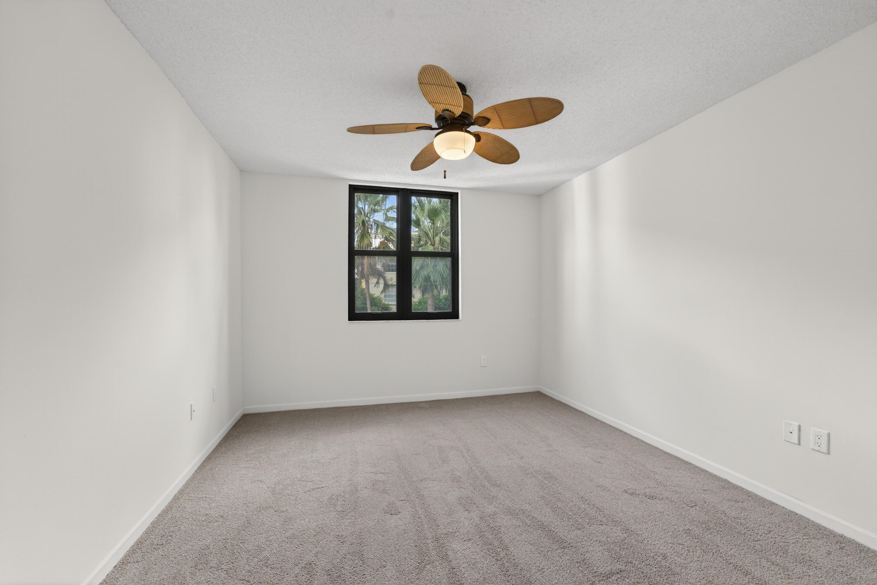 651 Okeechobee Boulevard, Unit 302 West Palm Beach, FL 33401 - Photo 14 of 29 an empty room with windows and fan