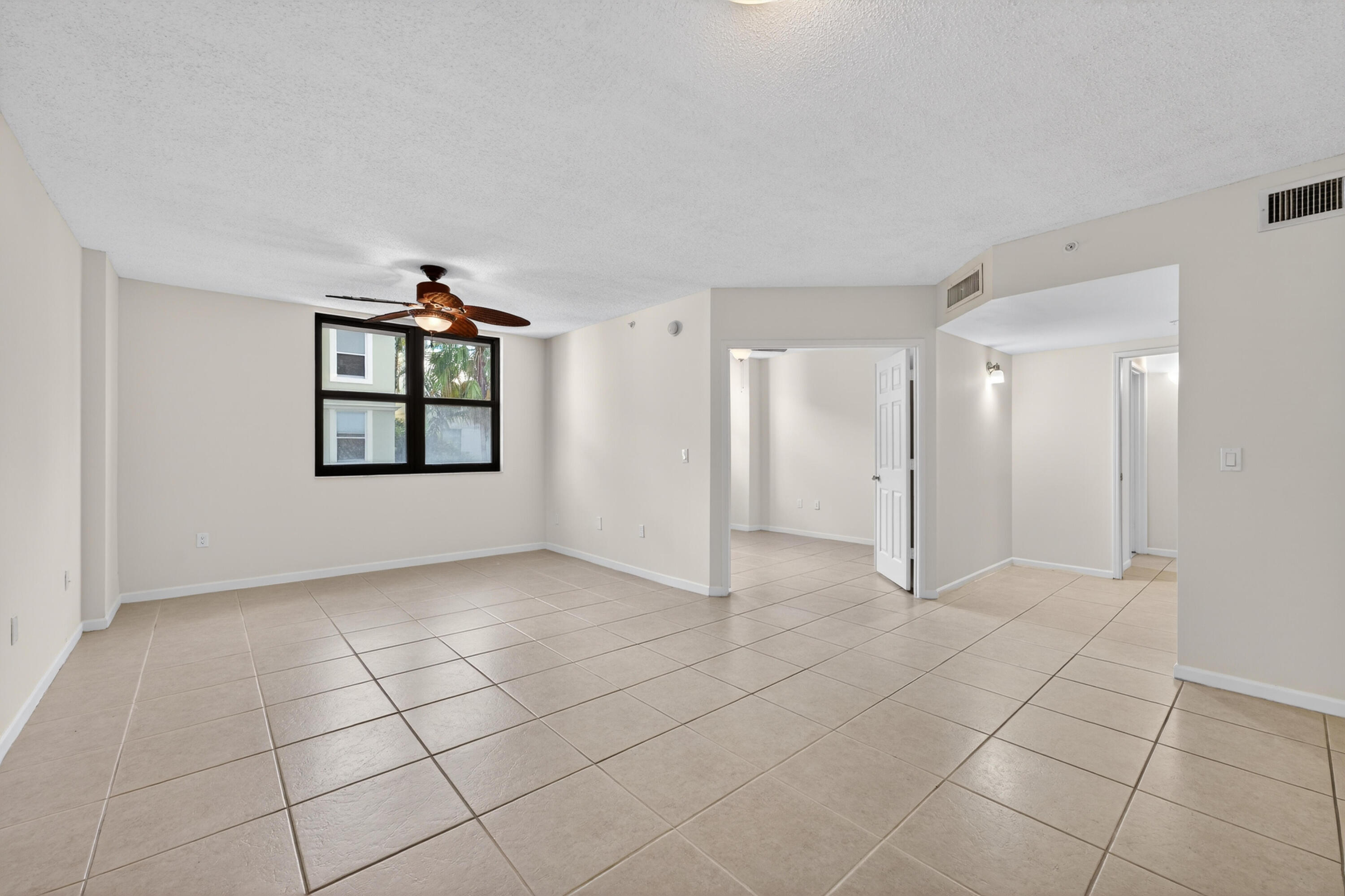 651 Okeechobee Boulevard, Unit 302 West Palm Beach, FL 33401 - Photo 18 of 29 a view of an empty room with a window