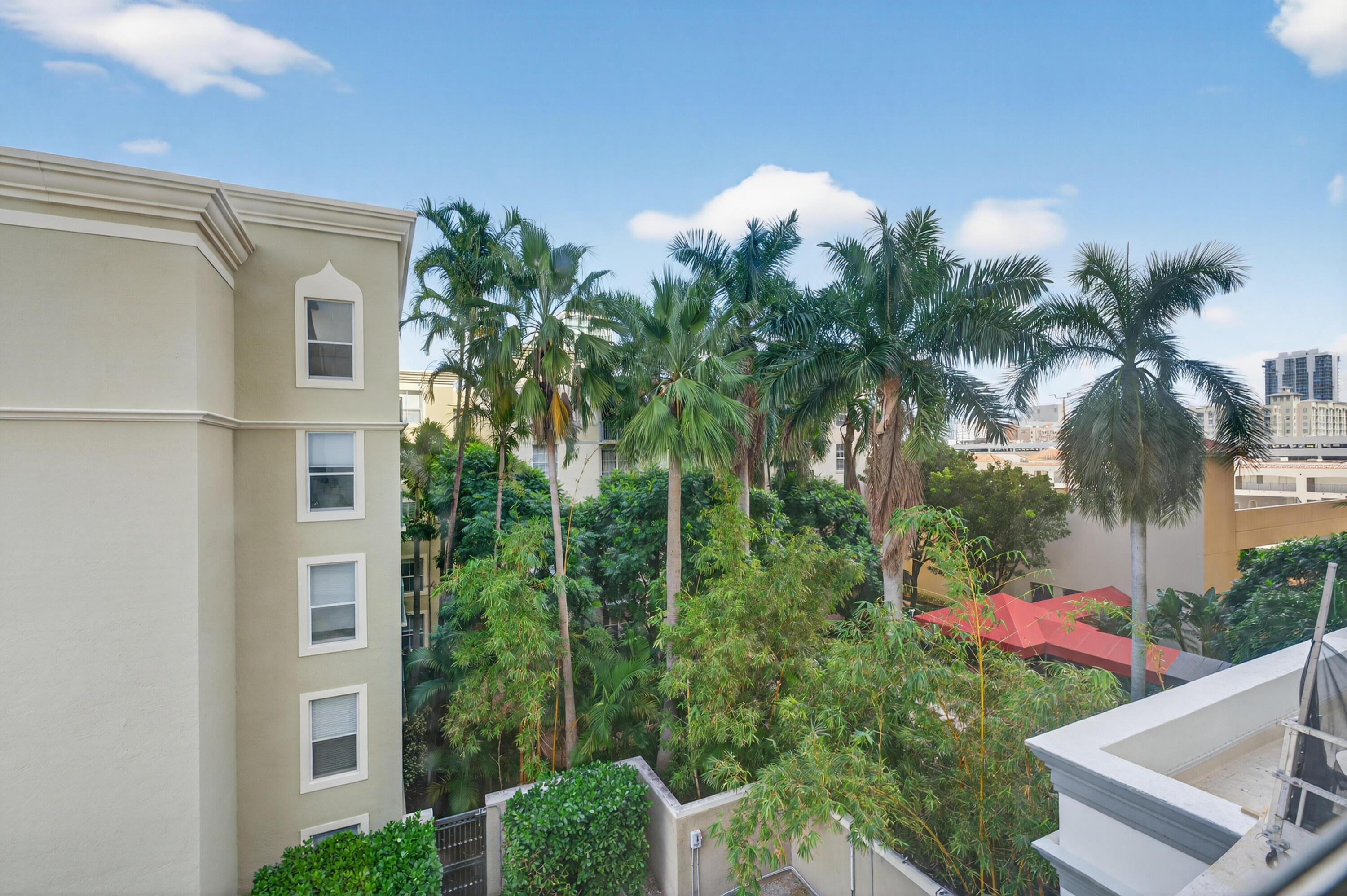 651 Okeechobee Boulevard, Unit 302 West Palm Beach, FL 33401 - Photo 21 of 29 a view of a white house with a yard and plants