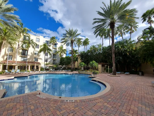 a view of a swimming pool with palm trees