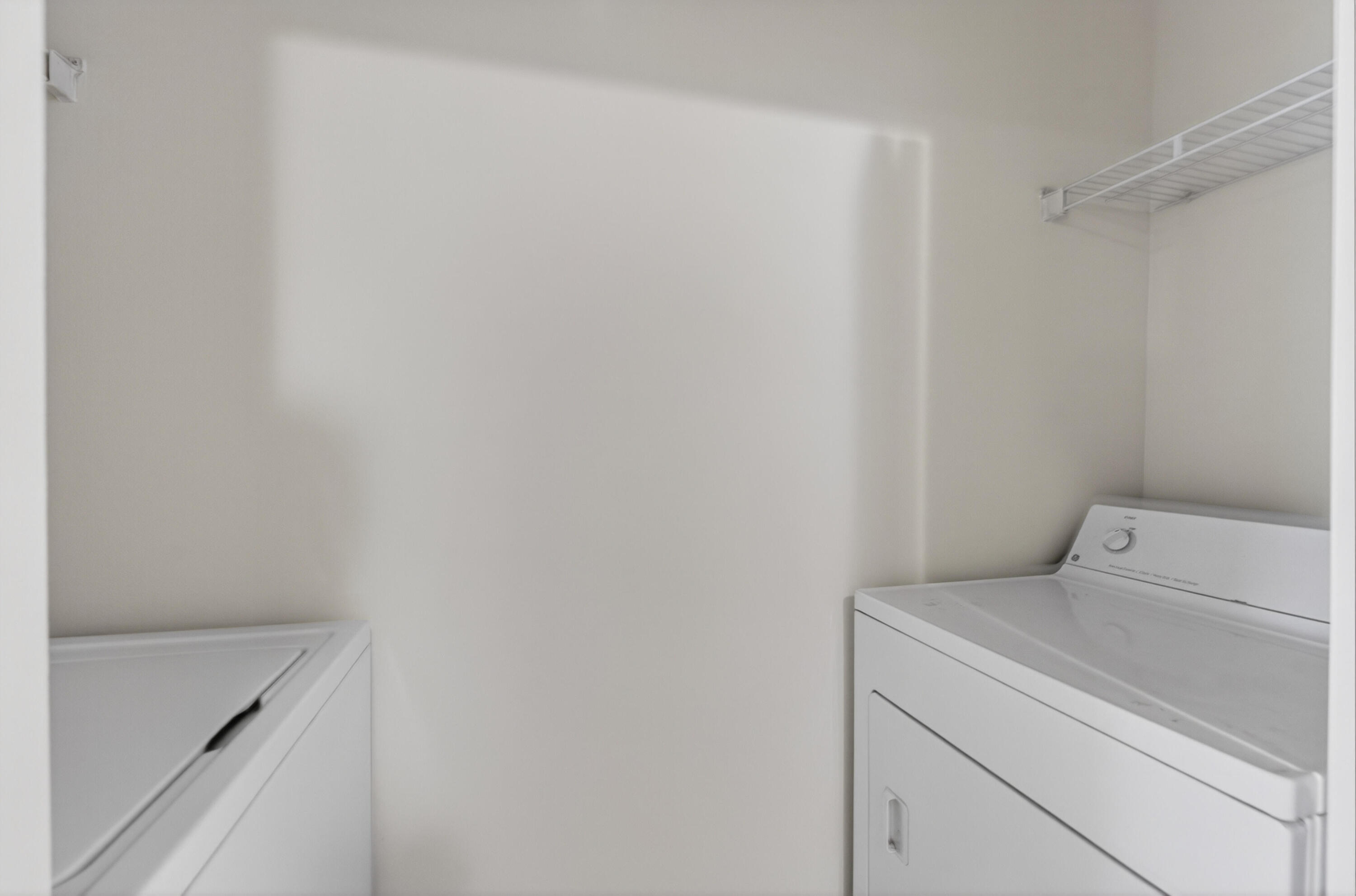 651 Okeechobee Boulevard, Unit 302 West Palm Beach, FL 33401 - Photo 3 of 29 a utility room with dryer and washer