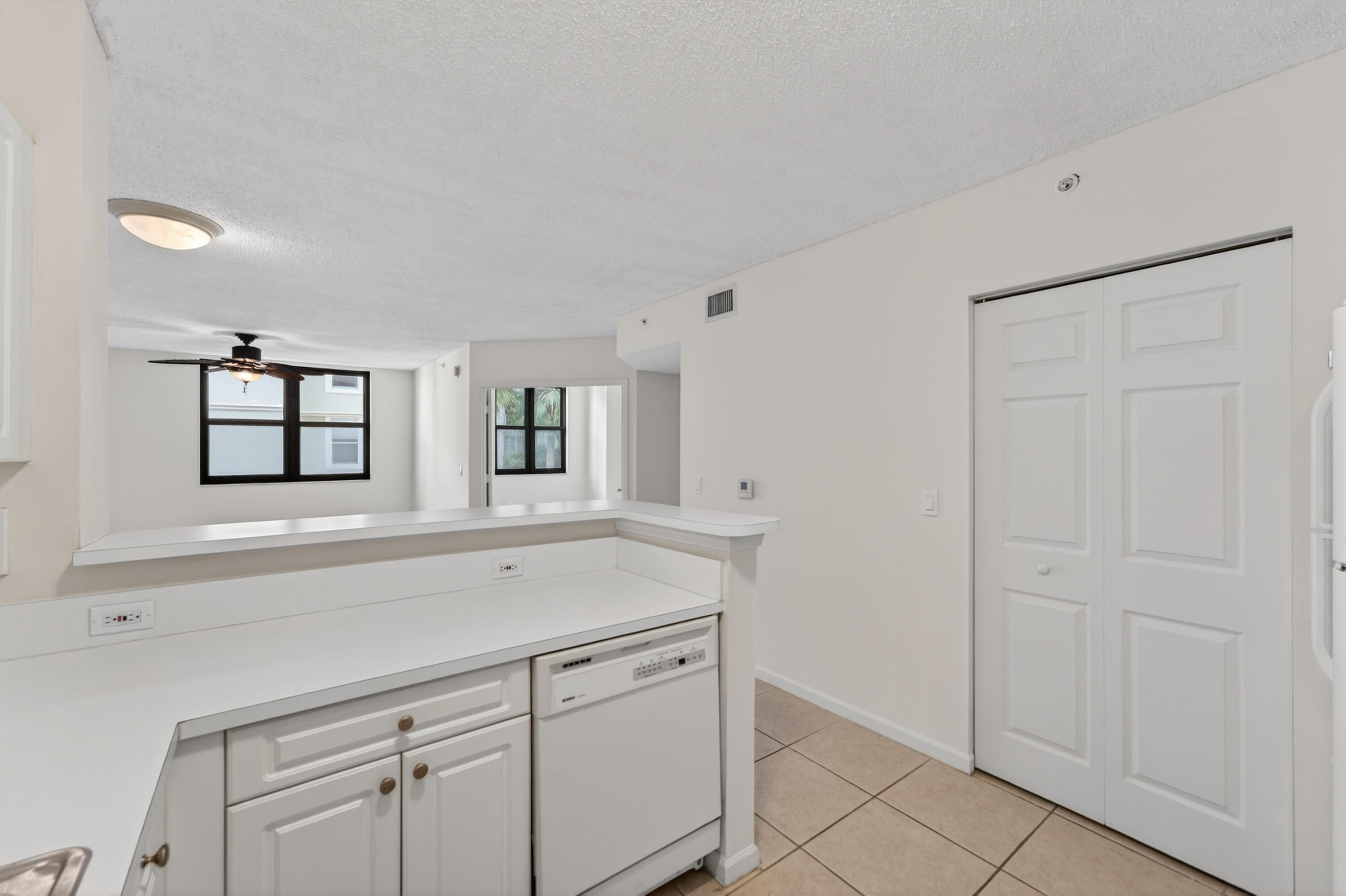 651 Okeechobee Boulevard, Unit 302 West Palm Beach, FL 33401 - Photo 6 of 29 a view with cabinets and window