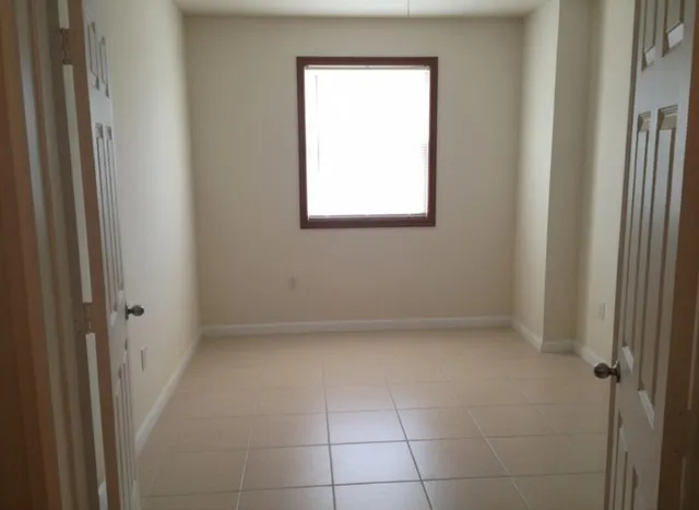 a view of an empty room with a window