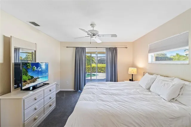 a bedroom with a flat screen television and a bed