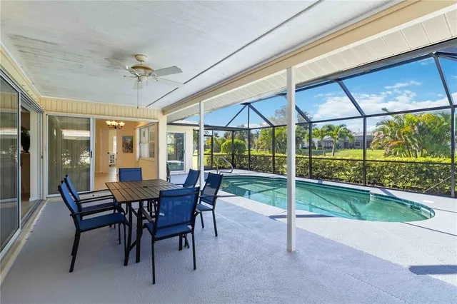 a view of a patio with a table chairs and a backyard
