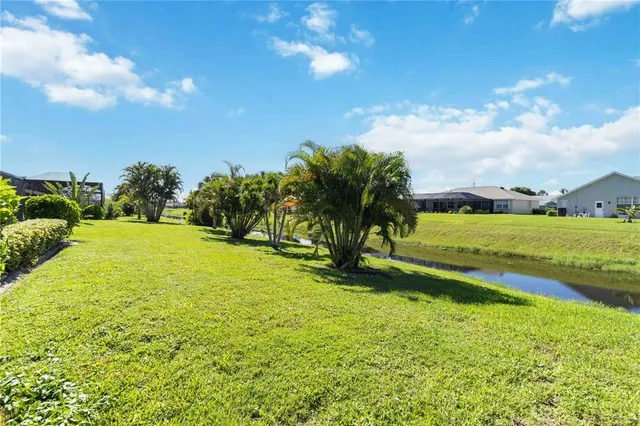 a view of yard with swimming pool and green space
