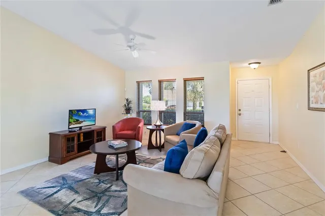 a living room with furniture a rug and a window
