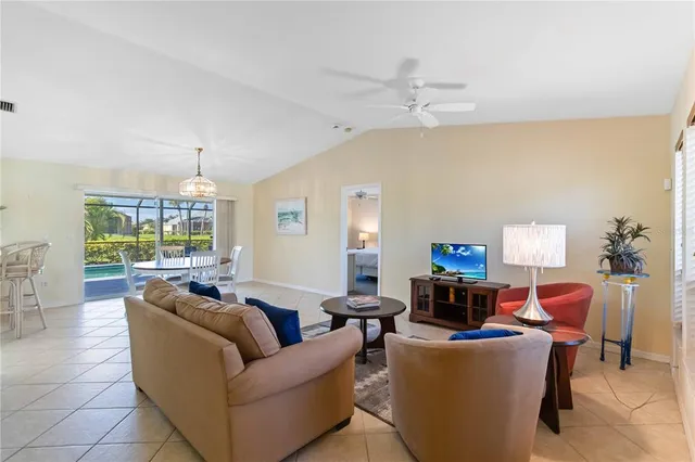 a living room with furniture a chandelier and a window