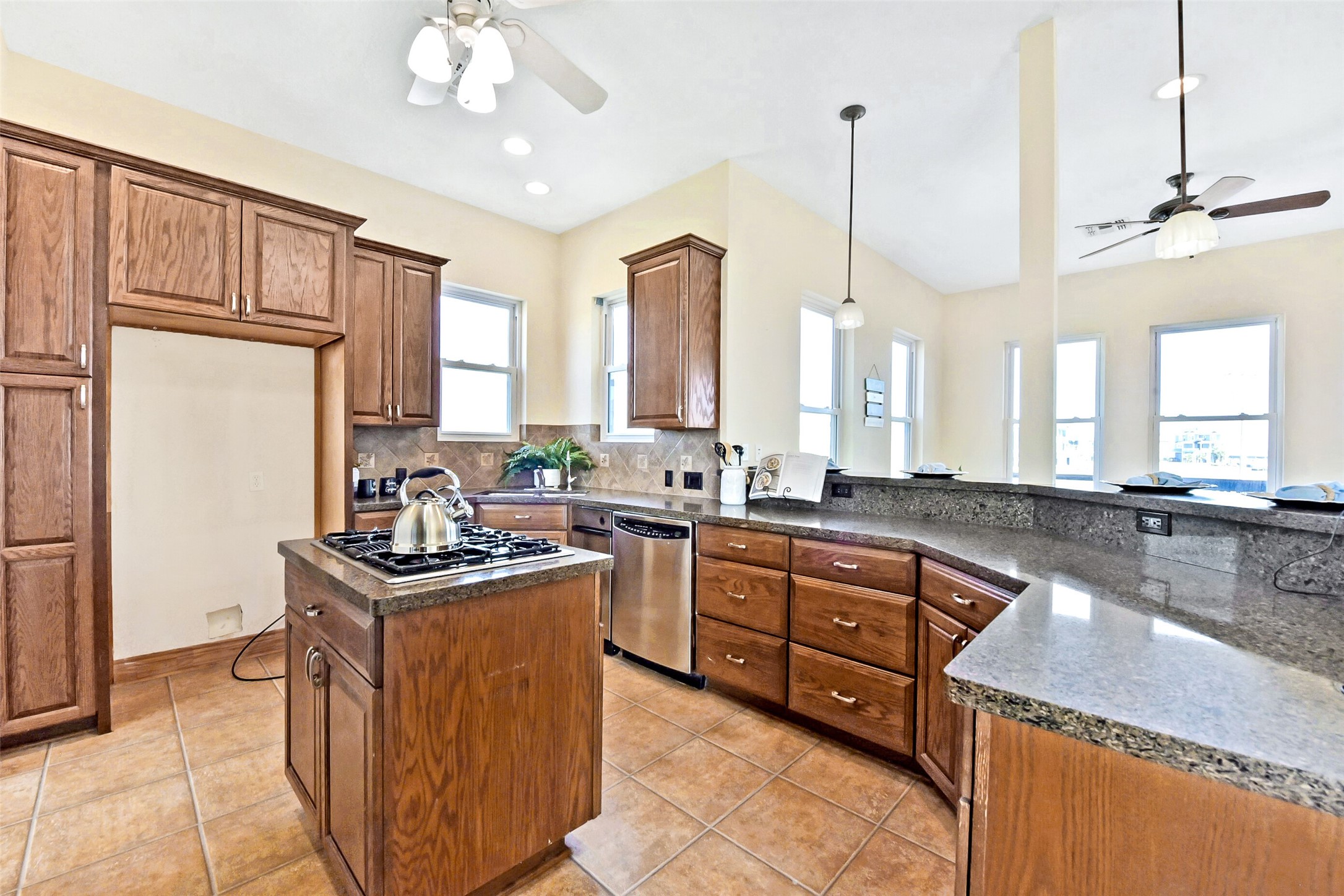 1 Loggerhead Hitchcock, TX 77563 - Photo 10 of 49 a kitchen with stainless steel appliances granite countertop a sink a stove and a refrigerator