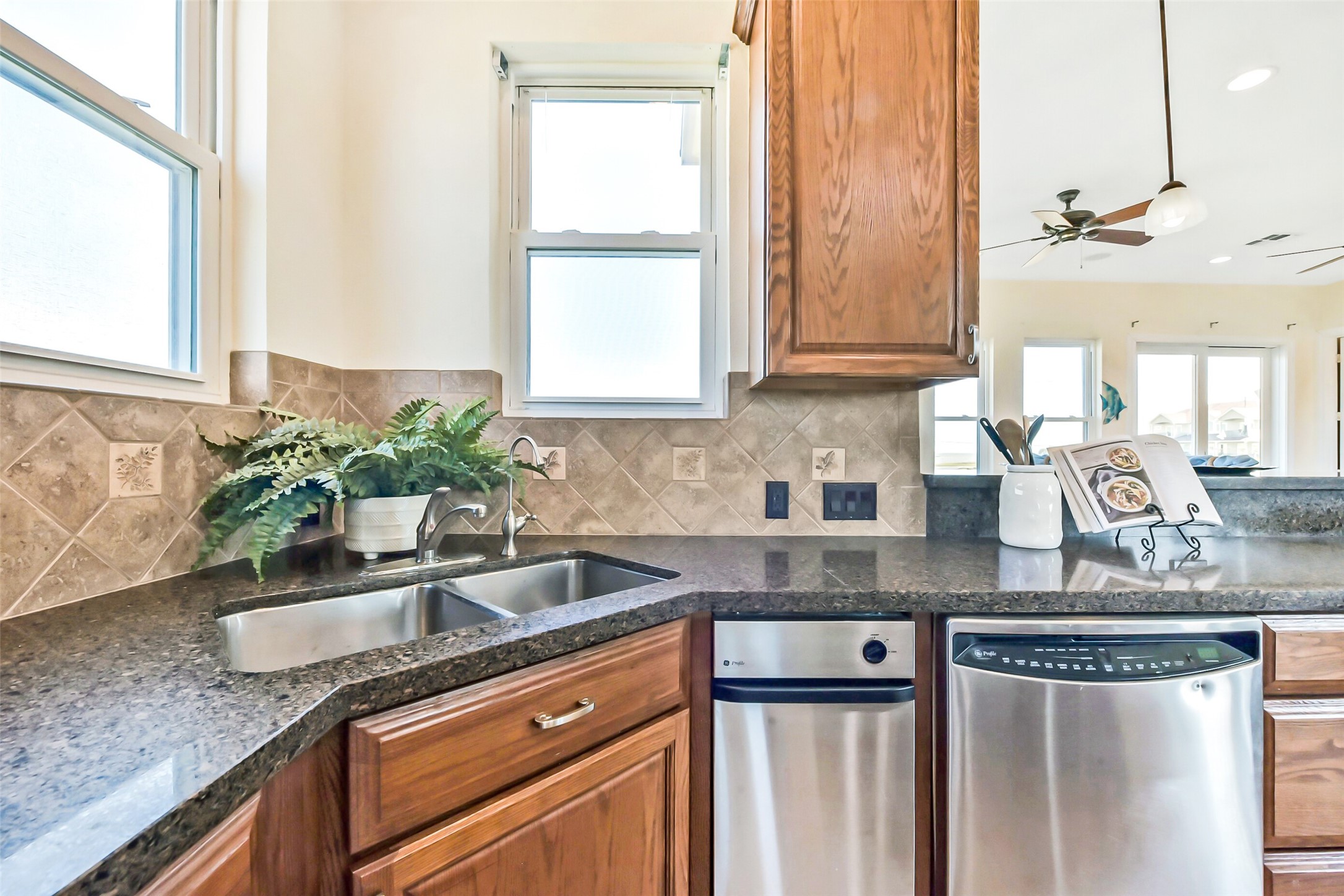 1 Loggerhead Hitchcock, TX 77563 - Photo 12 of 49 a kitchen with stainless steel appliances granite countertop a sink a counter space and a window