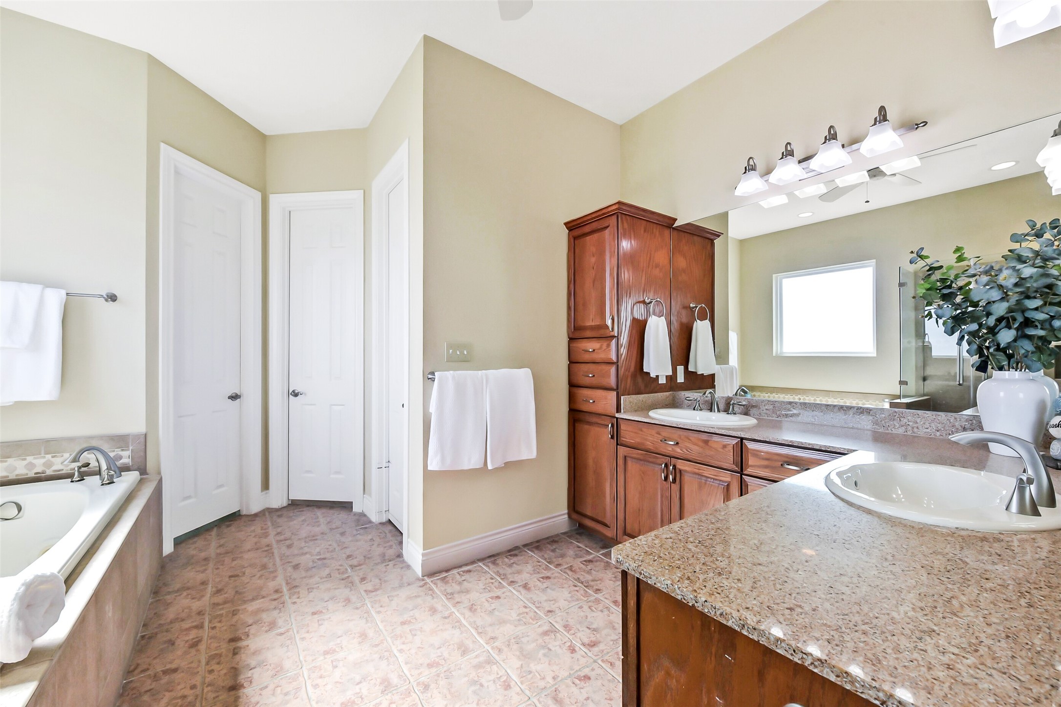 1 Loggerhead Hitchcock, TX 77563 - Photo 19 of 49 a spacious bathroom with a granite countertop sink a large mirror and a bathtub