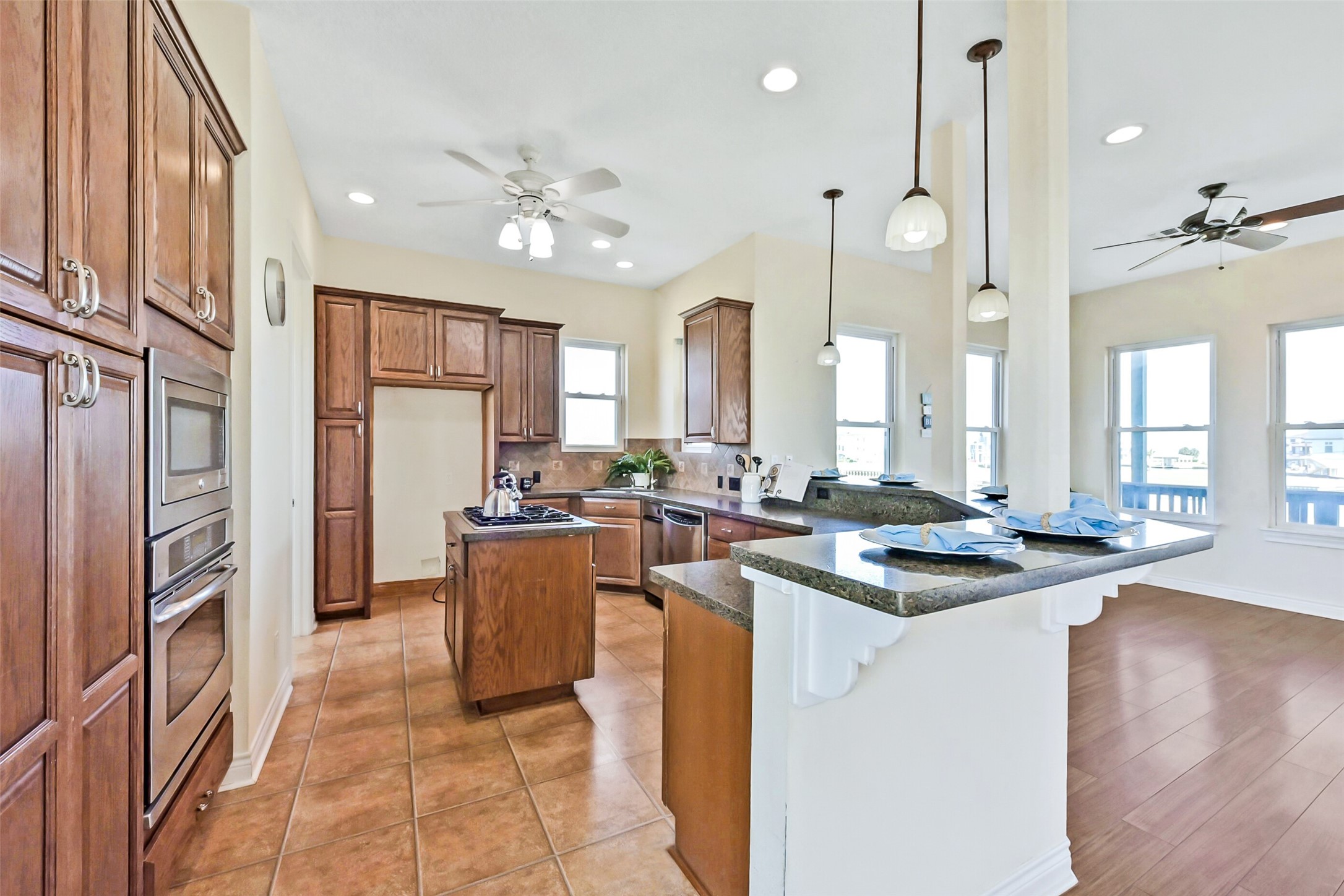 1 Loggerhead Hitchcock, TX 77563 - Photo 9 of 49 Island kitchen with custom plentiful cabinetry, breakfast bar.