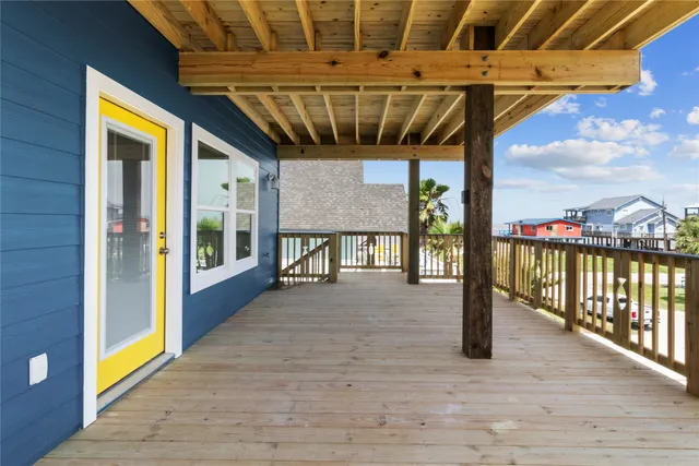 a view of a porch with a table and chairs