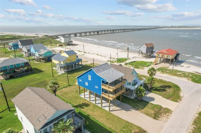 an aerial view of a house with swimming pool having outdoor seating