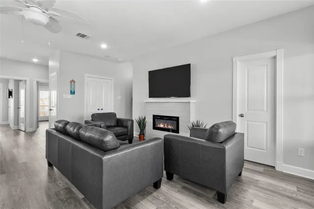 a living room with furniture a fireplace and a flat screen tv