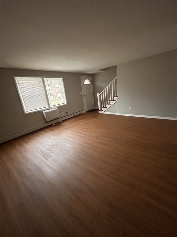 5 Manor Court, Unit 5 Springfield, MA 01118 - Photo 11 of 19 an empty room with wooden floor and windows