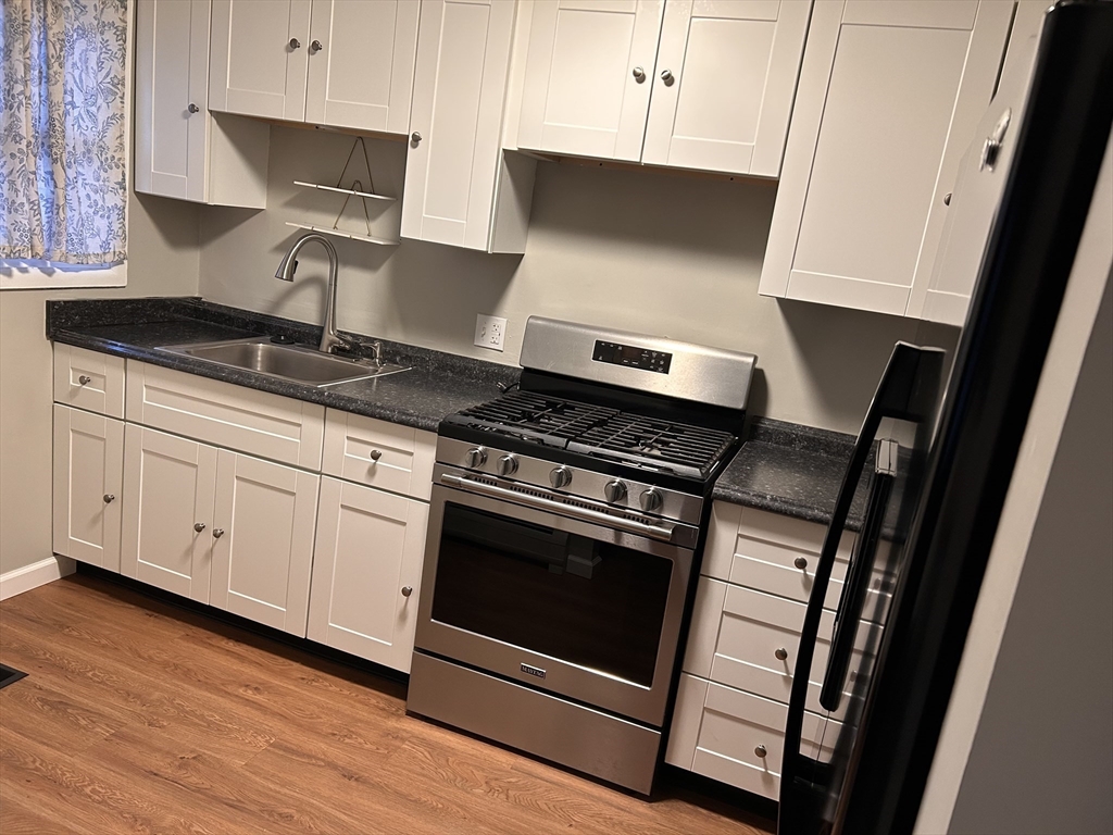 5 Manor Court, Unit 5 Springfield, MA 01118 - Photo 4 of 19 a stove top oven sitting inside of a kitchen