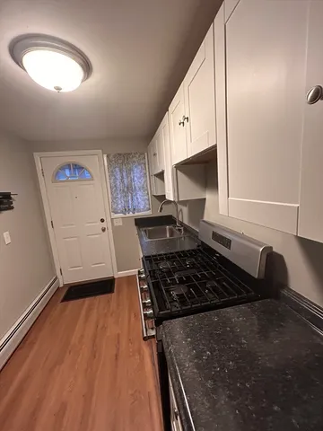 a kitchen with granite countertop a stove and a refrigerator