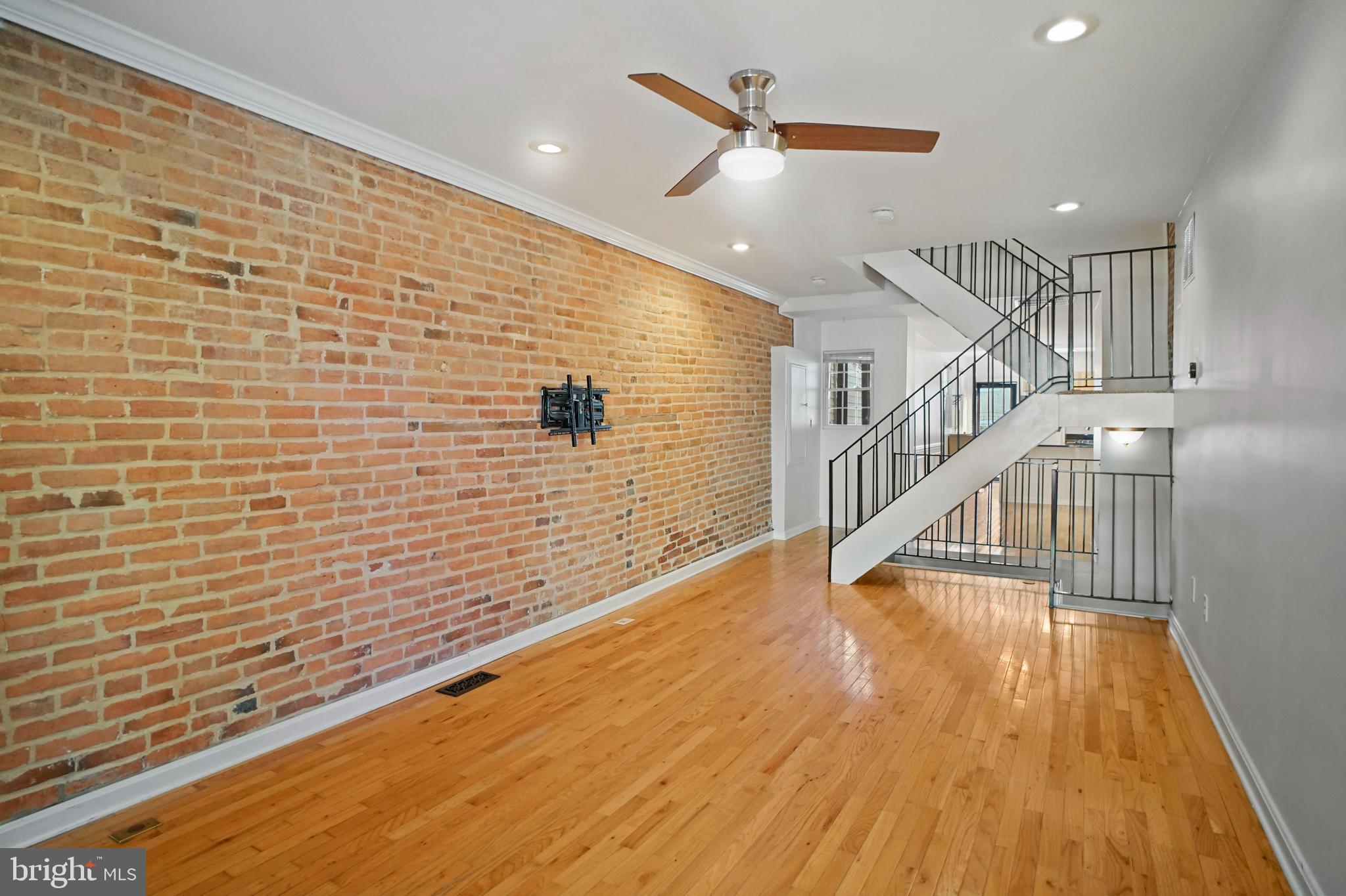 1417 Covington Street Baltimore, MD 21230 - Photo 3 of 25 Spacious living room with exposed brick walls