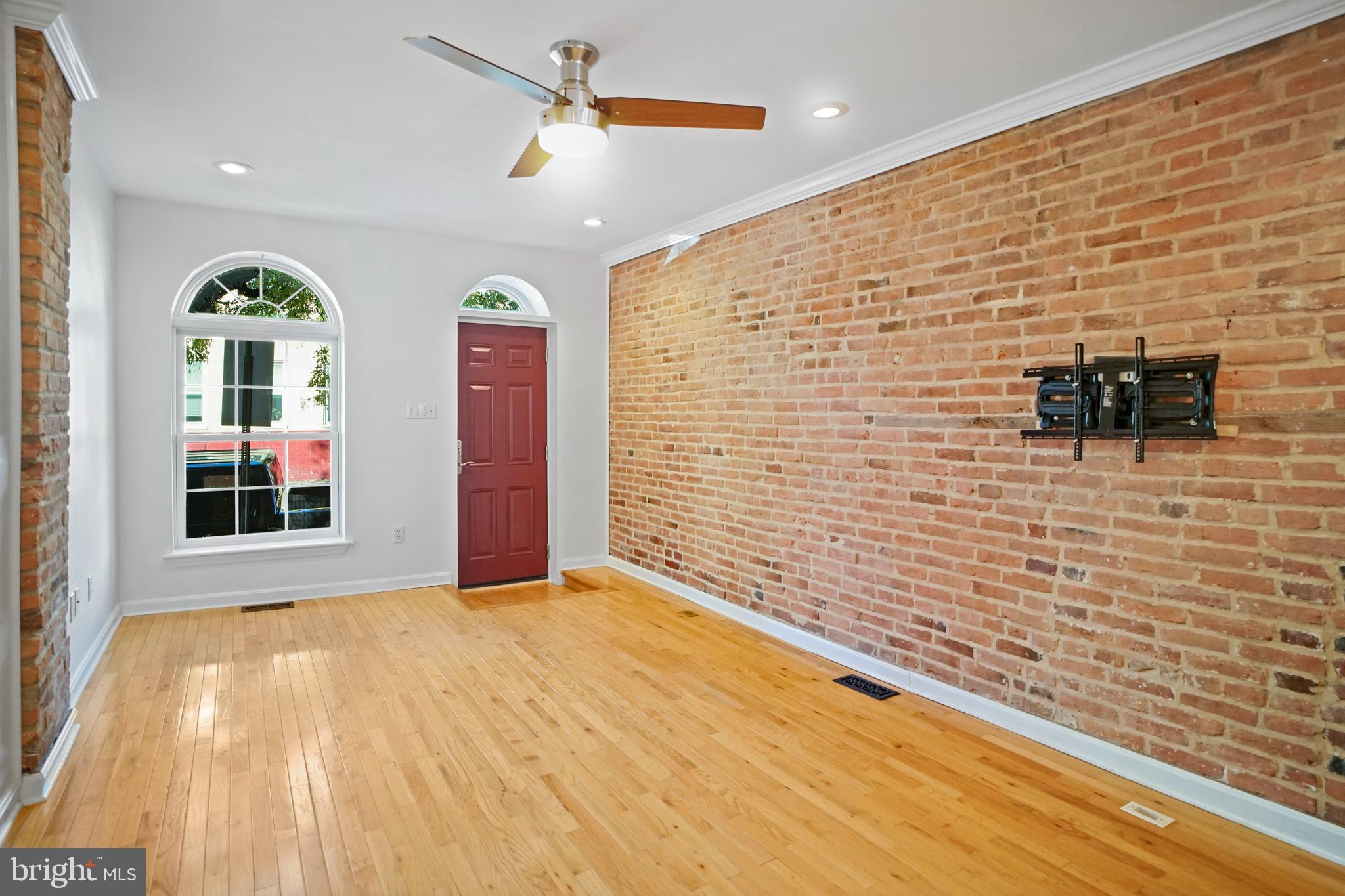 1417 Covington Street Baltimore, MD 21230 - Photo 4 of 25 Spacious living room with exposed brick walls
