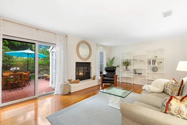 a living room with furniture a fireplace and a large window