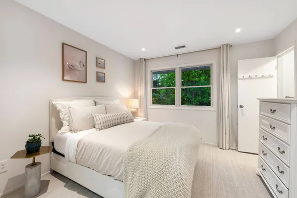 a bedroom with a large bed and a window