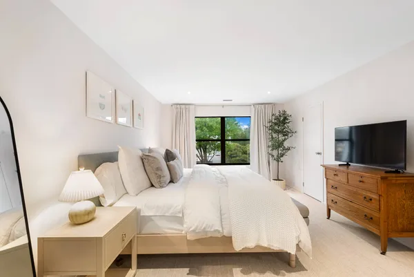 a bedroom with a bed and flat screen tv