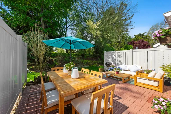 a view of a dinning table and chairs in the patio