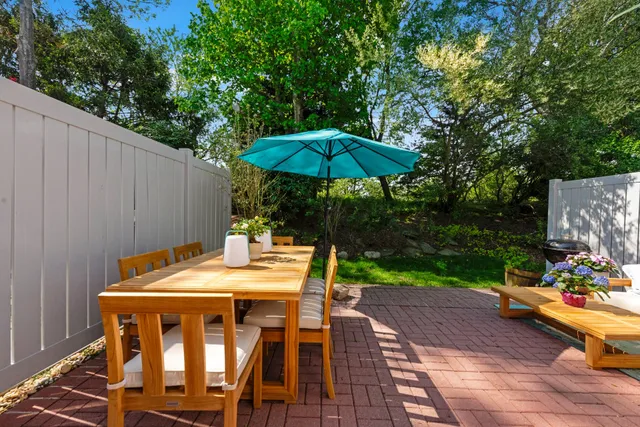 a view of backyard with seating space and trees