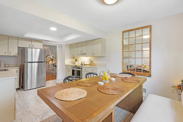 a kitchen with stainless steel appliances granite countertop a sink a refrigerator and a stove