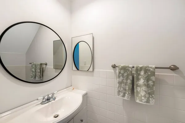 a bathroom with a sink a mirror and a shower