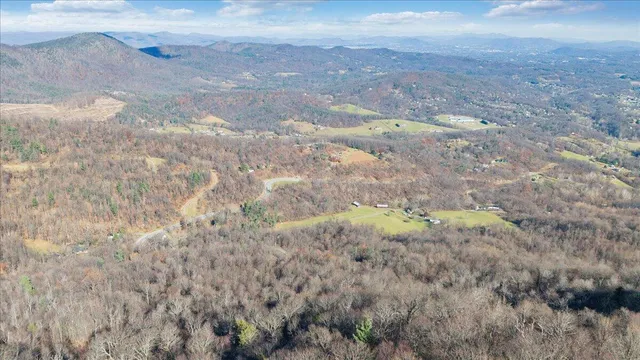 a view of a dry field with mountains in the background