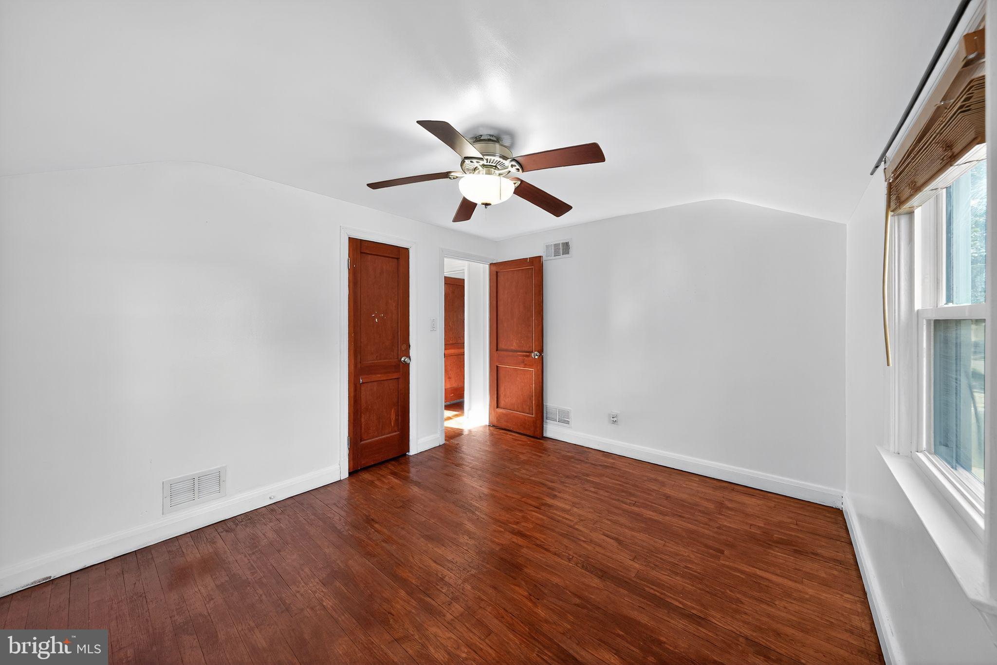 4401 Ridge Drive Baltimore, MD 21229 - Photo 11 of 30 wooden floor in an empty room with a window