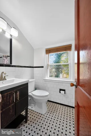 a bathroom with a sink toilet and mirror