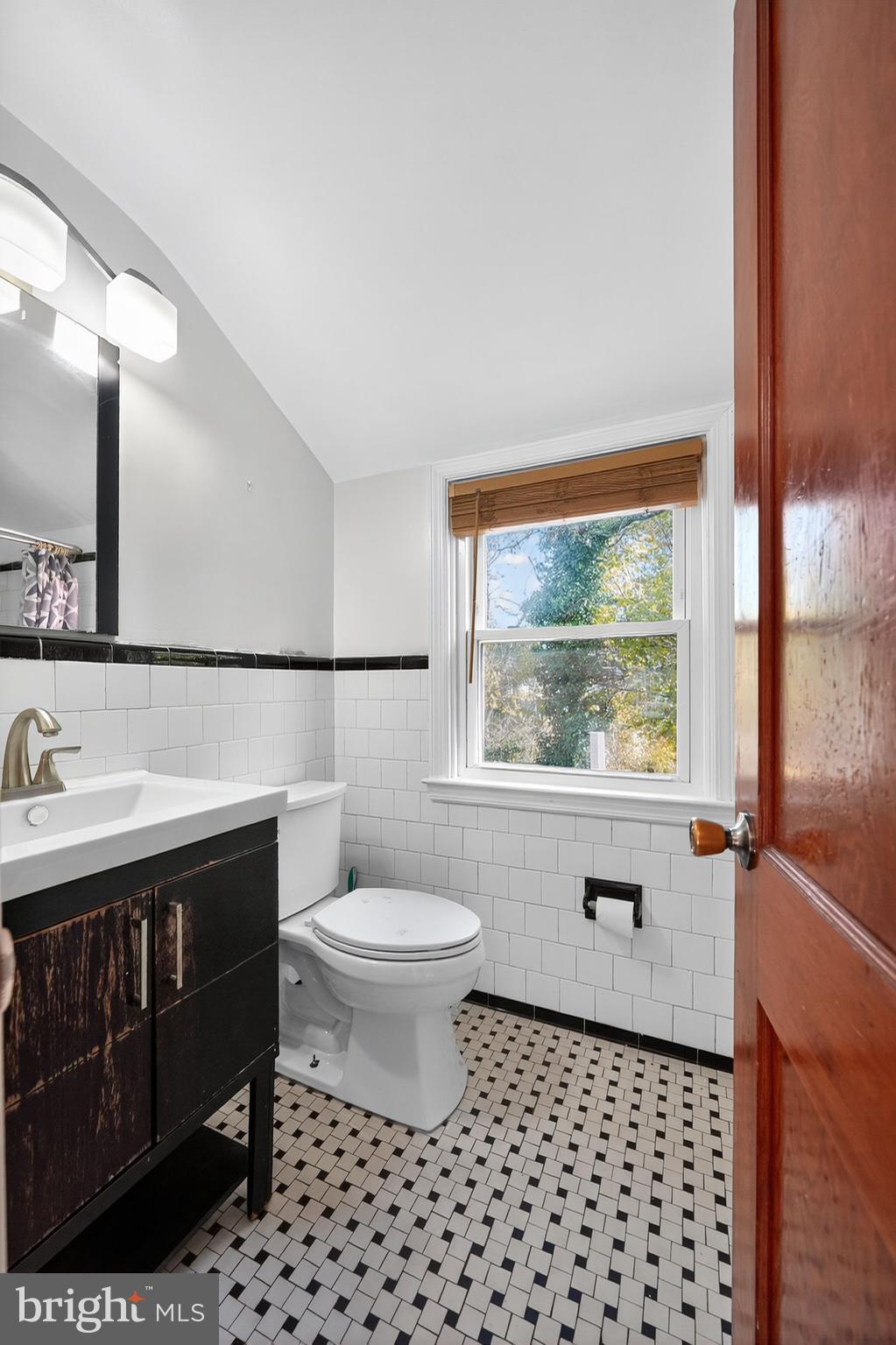 4401 Ridge Drive Baltimore, MD 21229 - Photo 20 of 30 a bathroom with a sink toilet and mirror