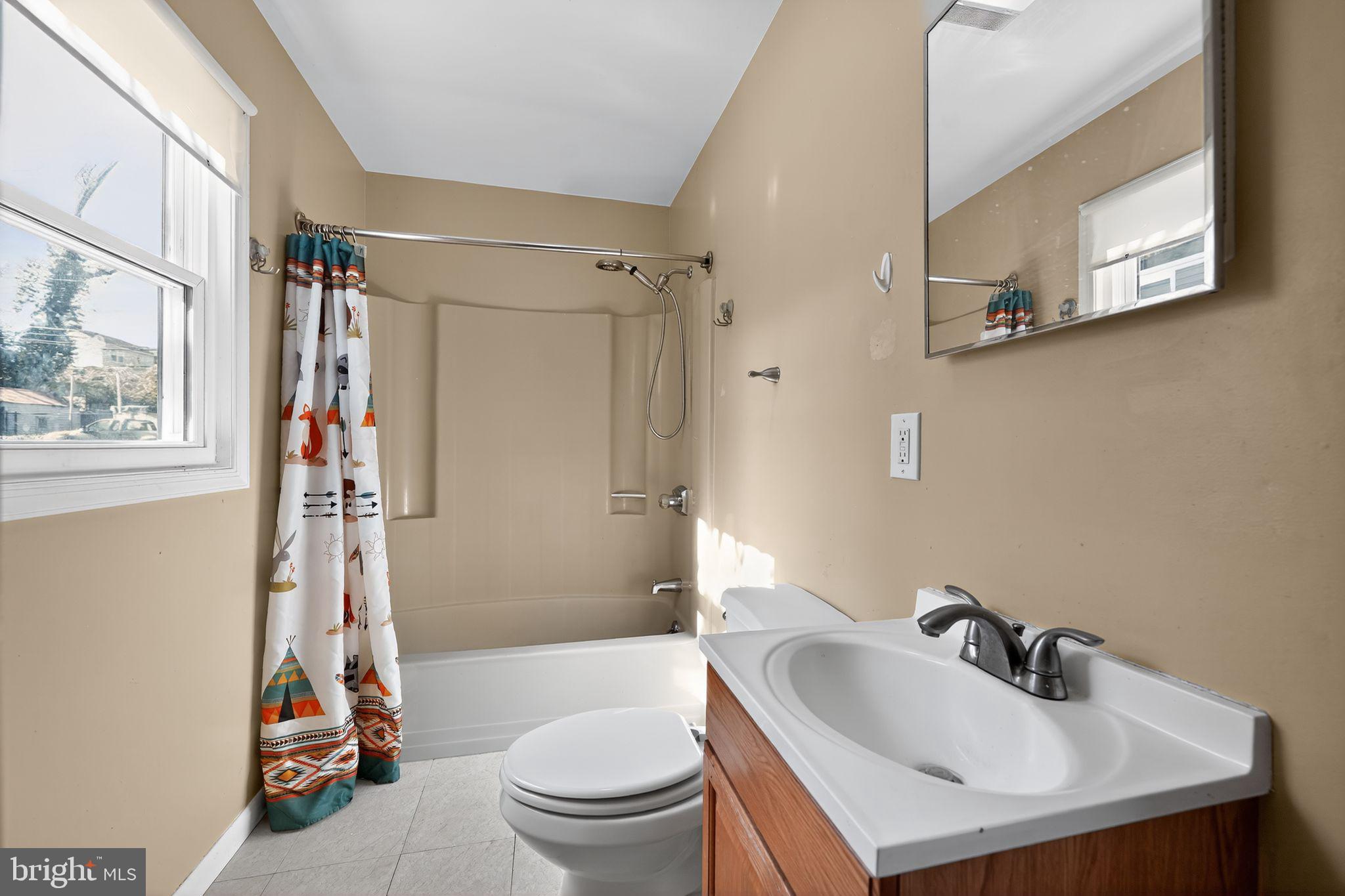 4401 Ridge Drive Baltimore, MD 21229 - Photo 21 of 30 a bathroom with a sink toilet and shower