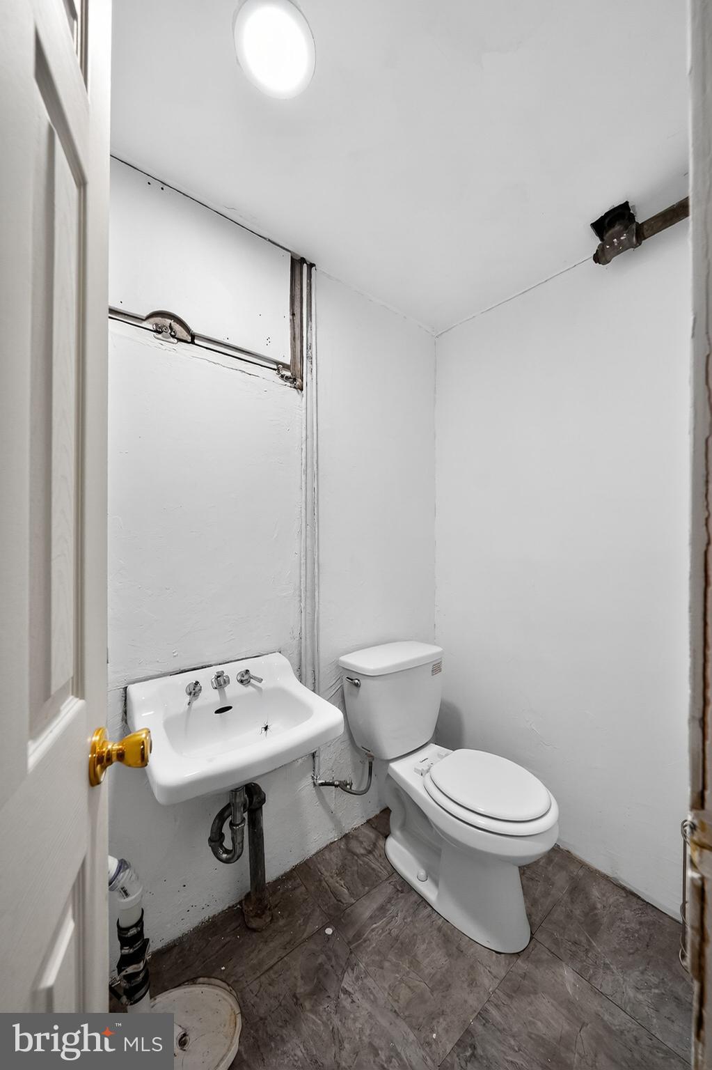 4401 Ridge Drive Baltimore, MD 21229 - Photo 22 of 30 a bathroom with a sink a toilet and shower