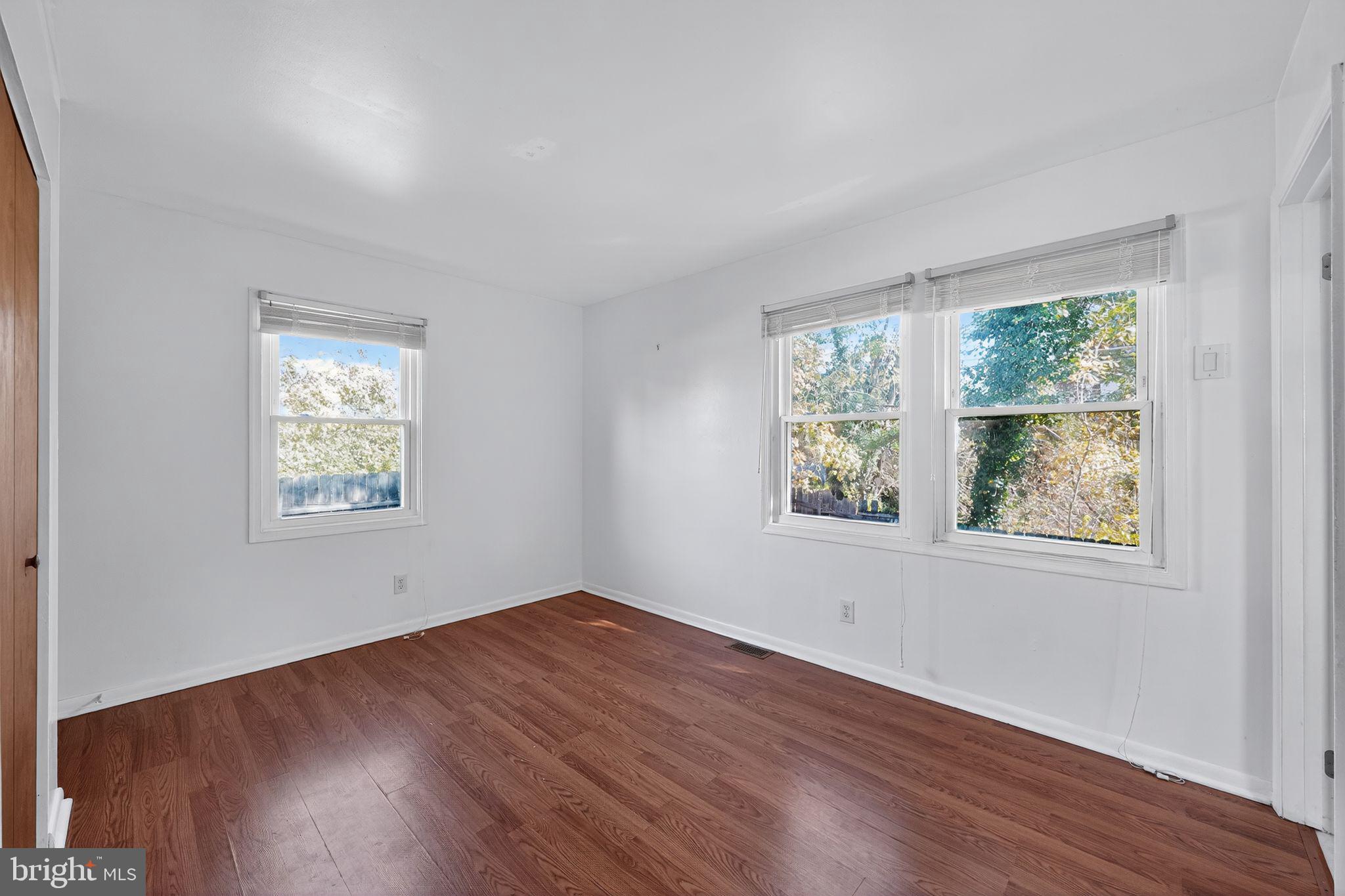 4401 Ridge Drive Baltimore, MD 21229 - Photo 10 of 30 a view of an empty room with wooden floor and a window
