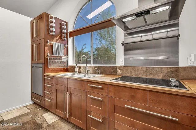 a kitchen with granite countertop a refrigerator and cabinets