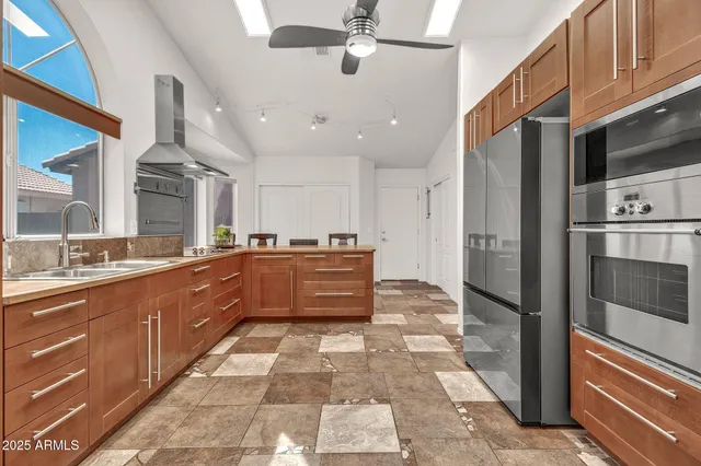 a kitchen with stainless steel appliances granite countertop a sink and cabinets